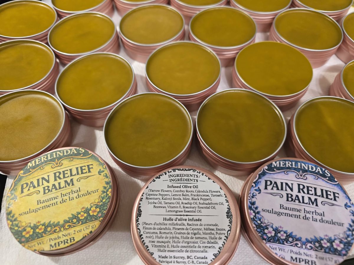 Merlinda's Botanical Pain Relief Balm in rose-gold tins
